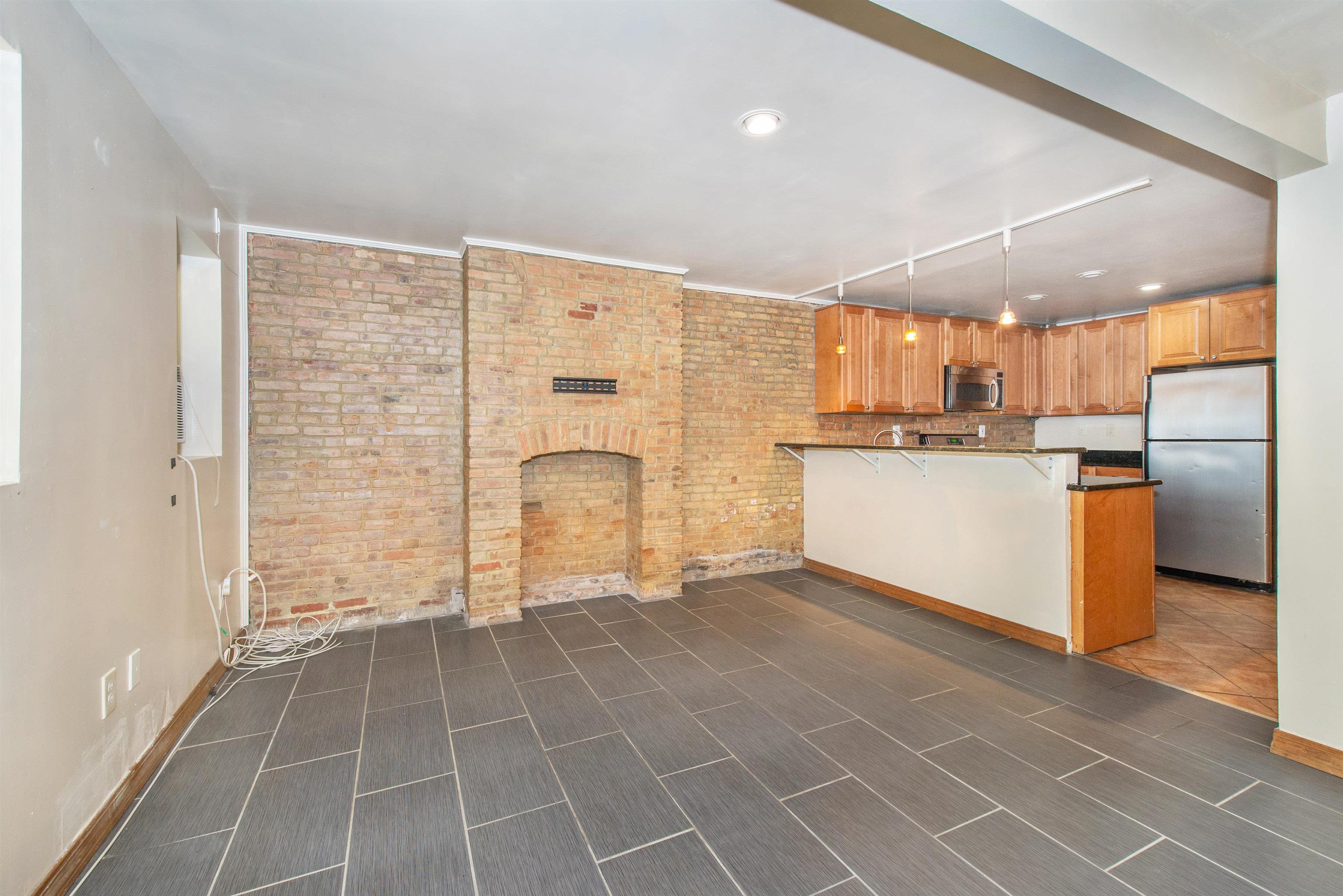 45 Monitor Street, Unit 1 Jersey City, NJ 07304 - Photo 3 of 14 a view of a kitchen with a sink cabinets and a window
