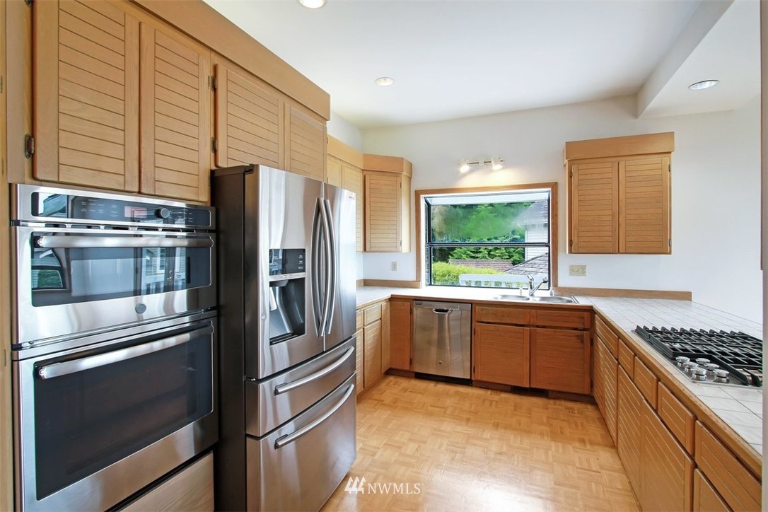 6720 139th Place Southwest Edmonds, WA 98026 - Photo 13 of 27 a kitchen with stainless steel appliances granite countertop a refrigerator and a stove top oven