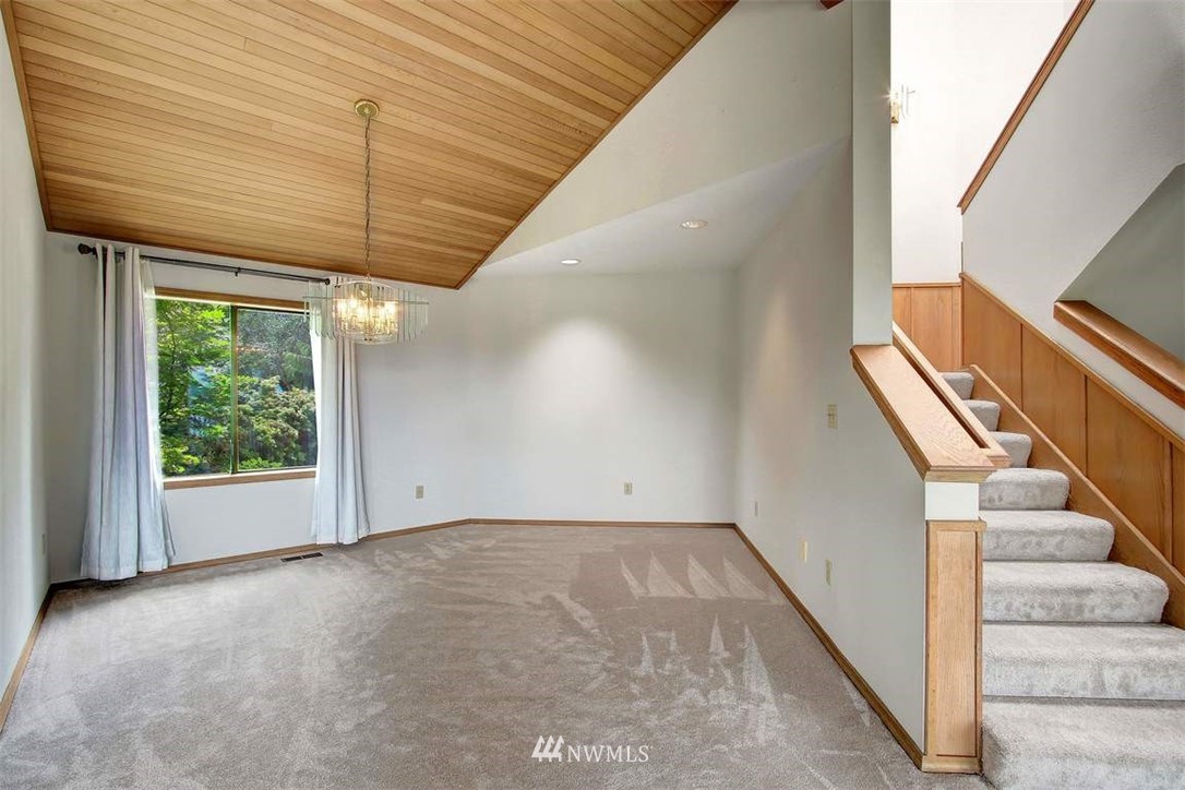 6720 139th Place Southwest Edmonds, WA 98026 - Photo 24 of 27 a view of an empty room with wooden floor and stairs