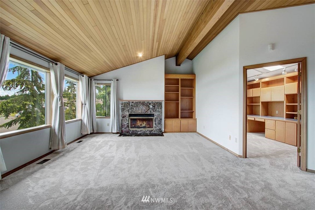 6720 139th Place Southwest Edmonds, WA 98026 - Photo 8 of 27 a view of an empty room with a fireplace and a window