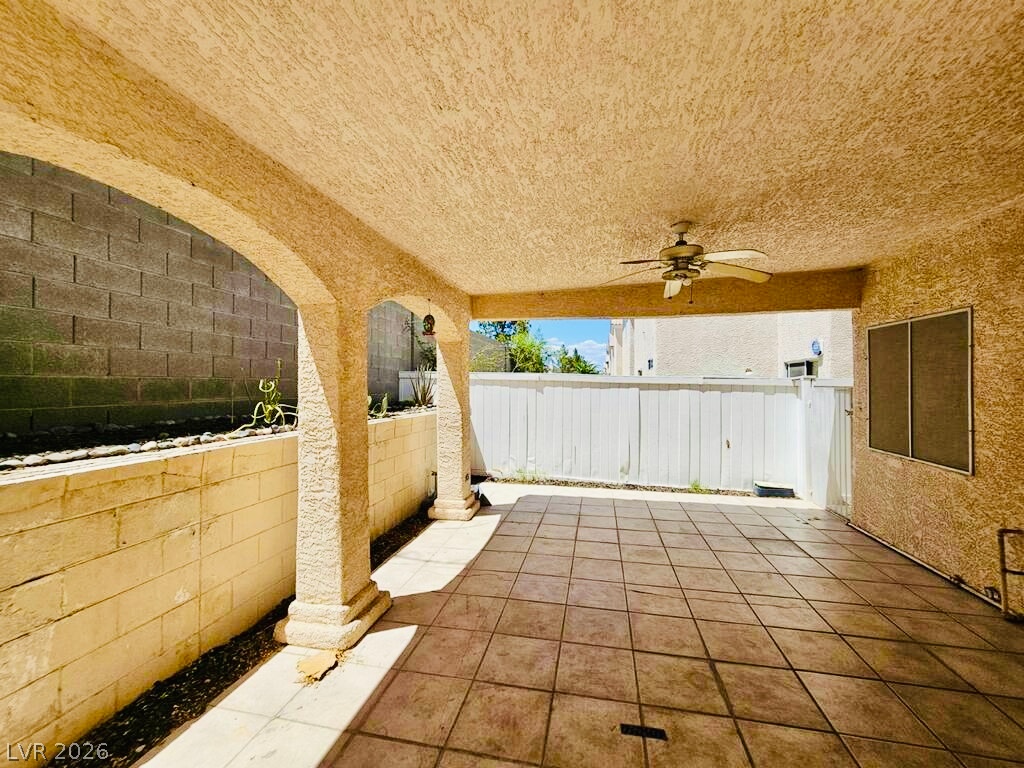 5953 Crumbling Ridge Street Henderson, NV 89011 - Photo 40 of 42 An inviting covered patio with durable tile flooring creates an ideal space for outdoor relaxation.