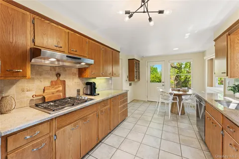 a kitchen with stainless steel appliances a sink stove and cabinets