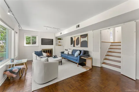 a living room with furniture and wooden floor