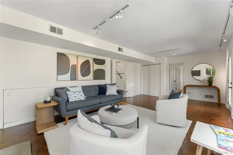 a living room with furniture and white walls
