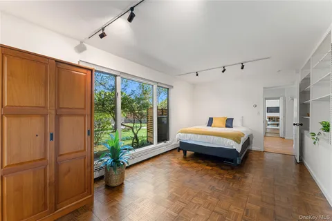 a spacious bedroom with a bed and a window