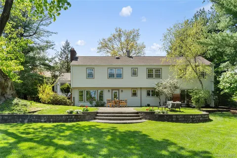 a front view of a house with swimming pool and yard
