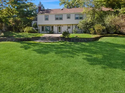 a front view of house with yard and green space
