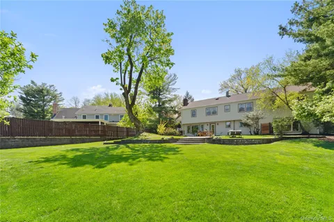 a view of yard with swimming pool and green space