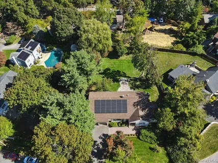 an aerial view of house with yard and outdoor seating