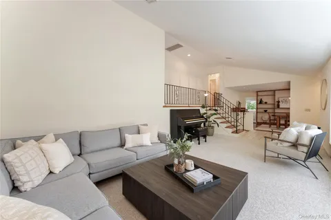 a living room with furniture hard wood floor and a fireplace
