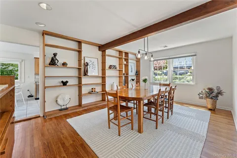 a dining room with wooden floor and breakfast area