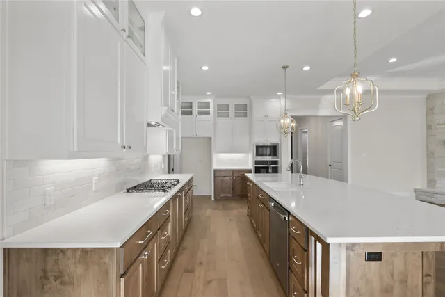 a large kitchen with a large counter top appliances and cabinets