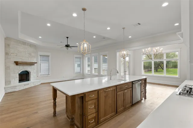 an open kitchen with a sink and a large window