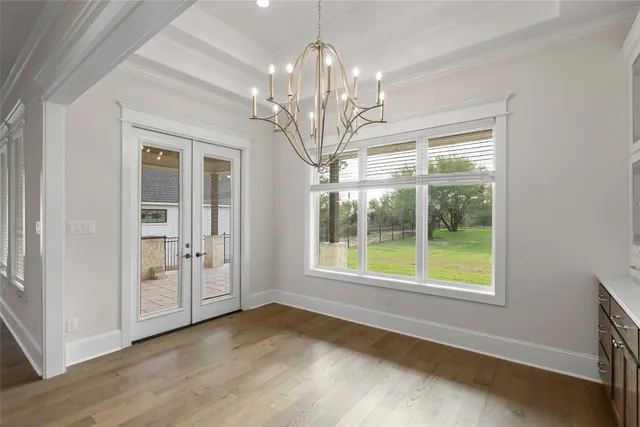 a view of a room with windows and chandelier