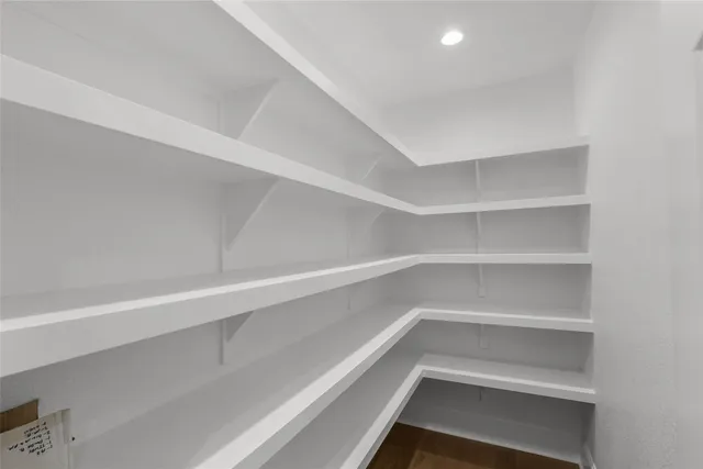 a view of walk in closet with empty racks
