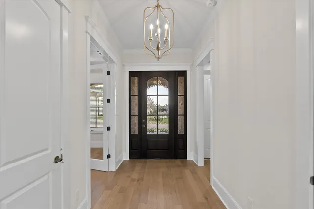 wooden floor in a hall with a chandelier