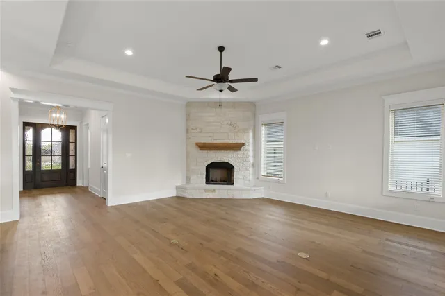 a view of a livingroom with a fireplace and window