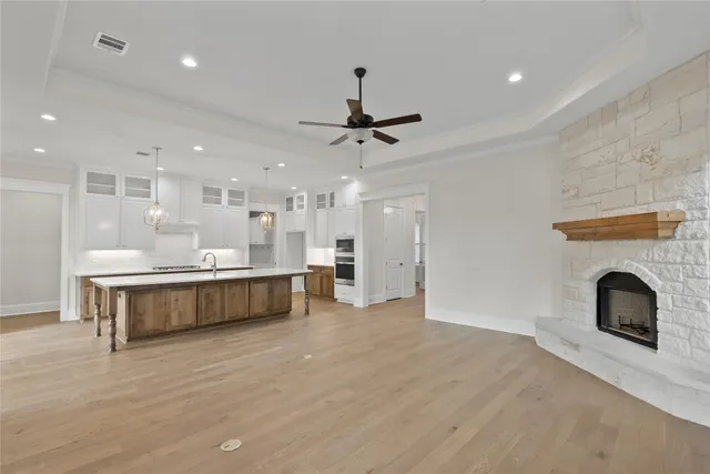 a view of a kitchen with a sink and a fireplace