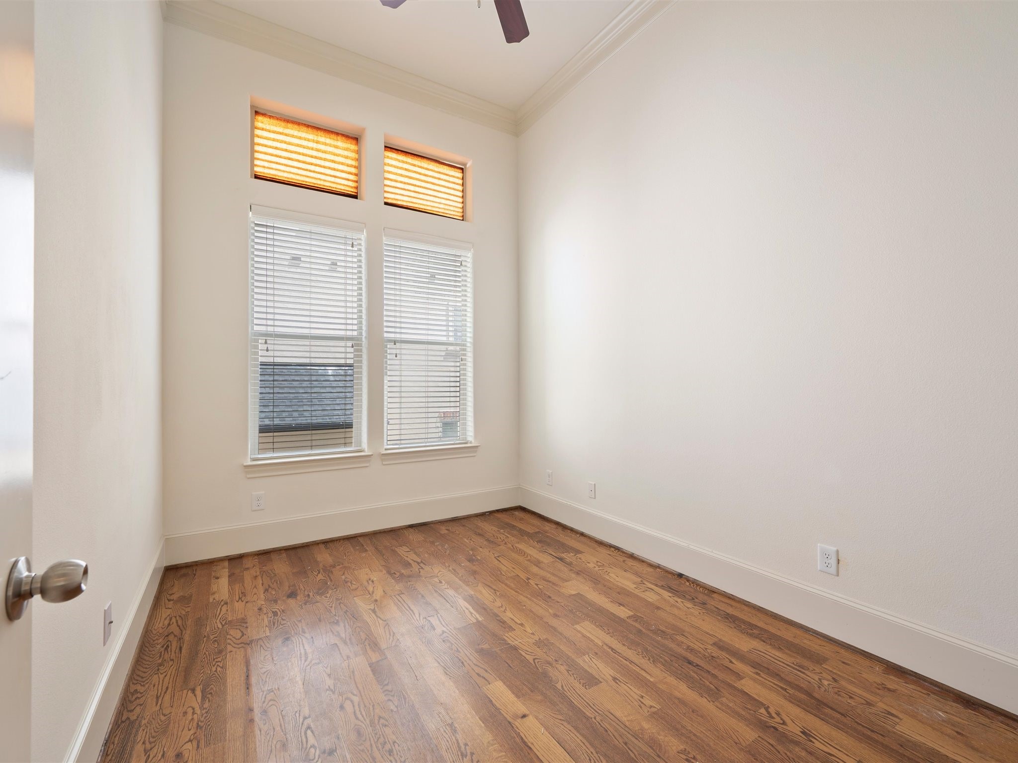 9427 London Bridge Station Houston, TX 77045 - Photo 17 of 30 This bright and inviting room boasts hardwood floors, a high ceiling with a fan, and large windows that flood the space with natural light.