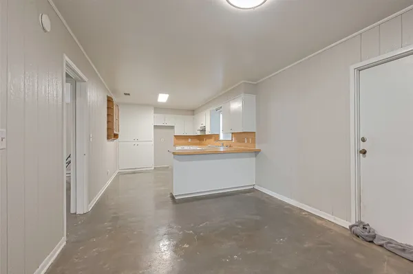 a kitchen with white cabinets and sink
