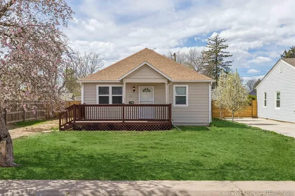 a view of a house with a yard and fence