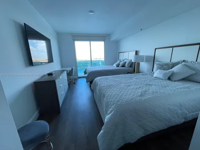 a bedroom with bed and window