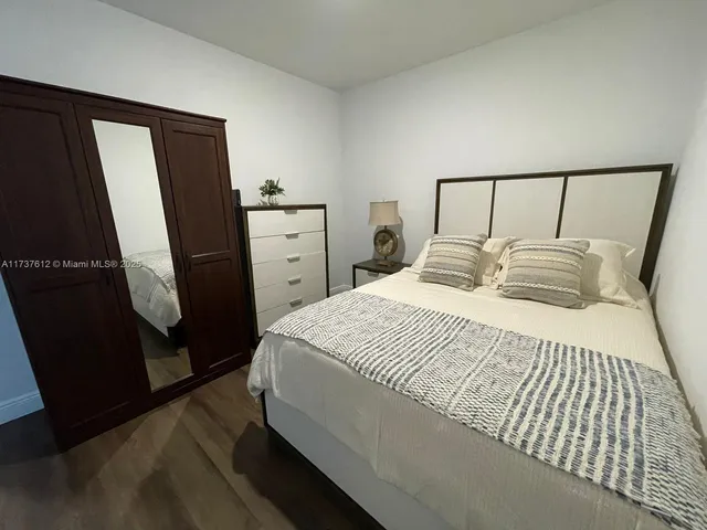 a bedroom with a bed and a mirror