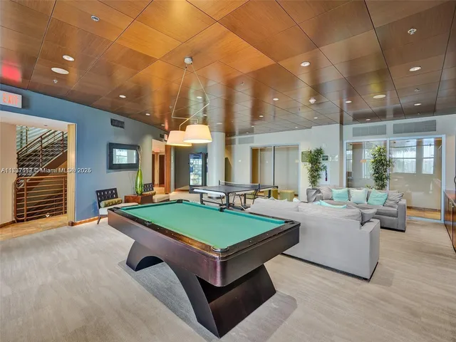 a living room with furniture a table and chairs