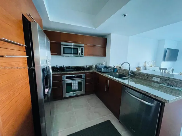 a kitchen with stainless steel appliances a stove sink and cabinets