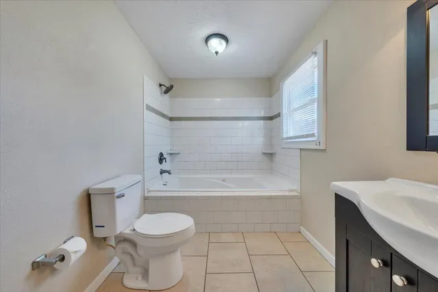 a bathroom with a toilet a sink and bathtub