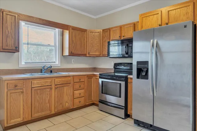 a kitchen with stainless steel appliances granite countertop a refrigerator and a sink