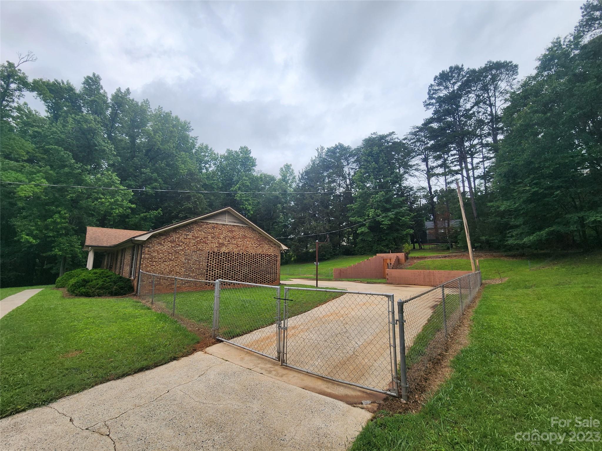 128 Devine Street Stanley, NC 28164 - Photo 15 of 36 a view of a house with backyard and a tree