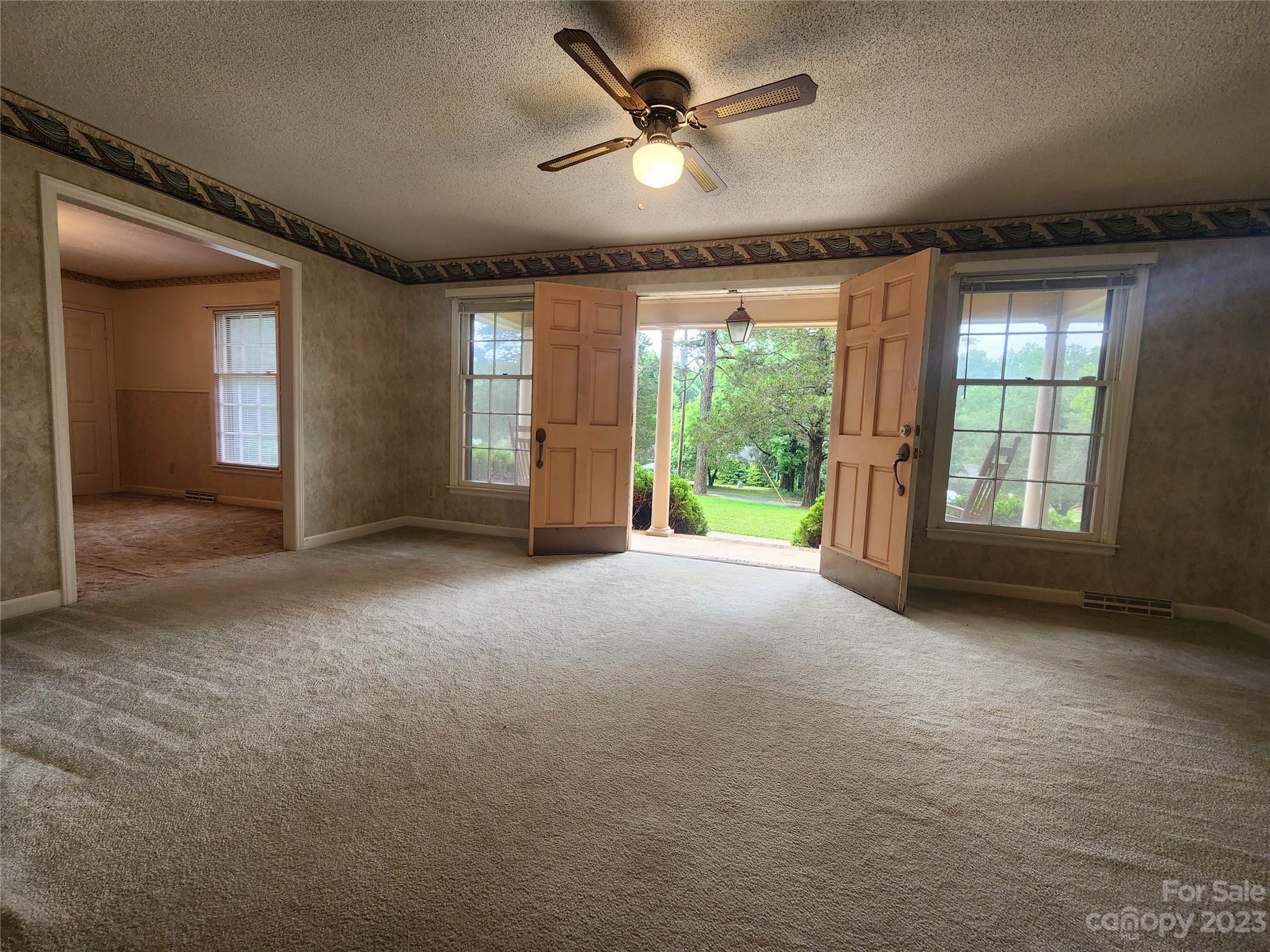 128 Devine Street Stanley, NC 28164 - Photo 19 of 36 a view of a livingroom with a ceiling fan and window