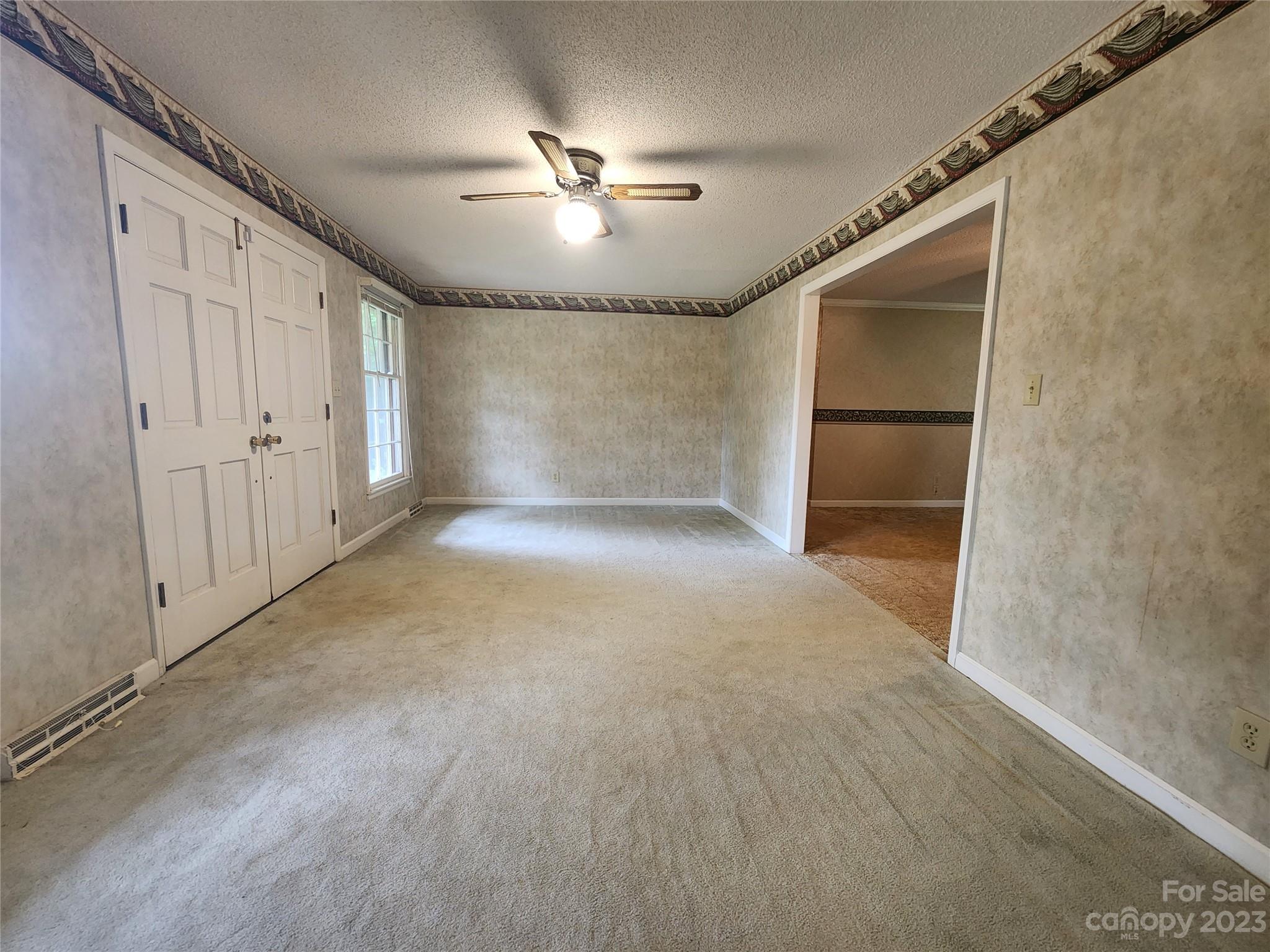 128 Devine Street Stanley, NC 28164 - Photo 20 of 36 a view of a livingroom with a ceiling fan and window