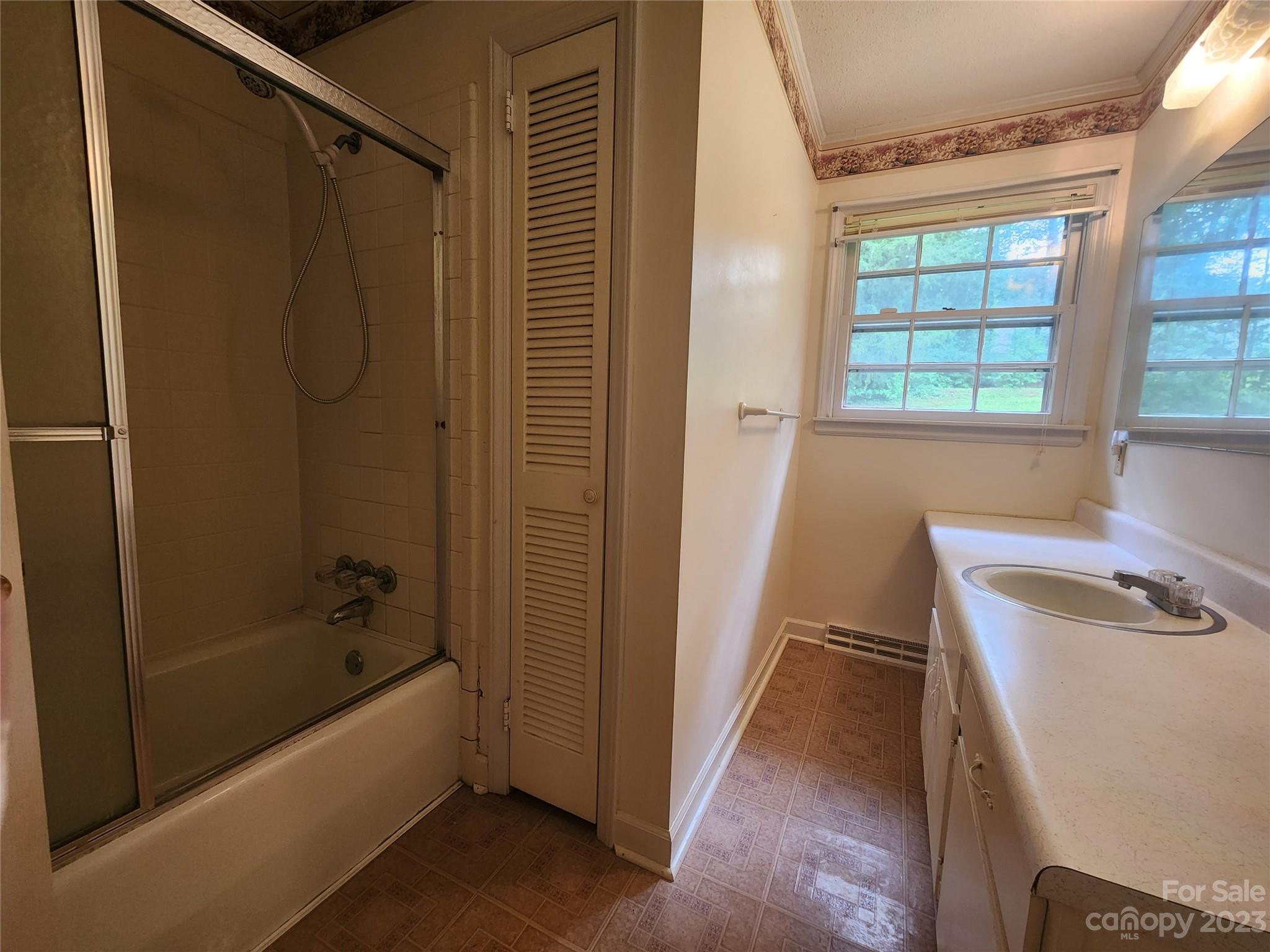 128 Devine Street Stanley, NC 28164 - Photo 25 of 36 a bathroom with a tub a sink and a window