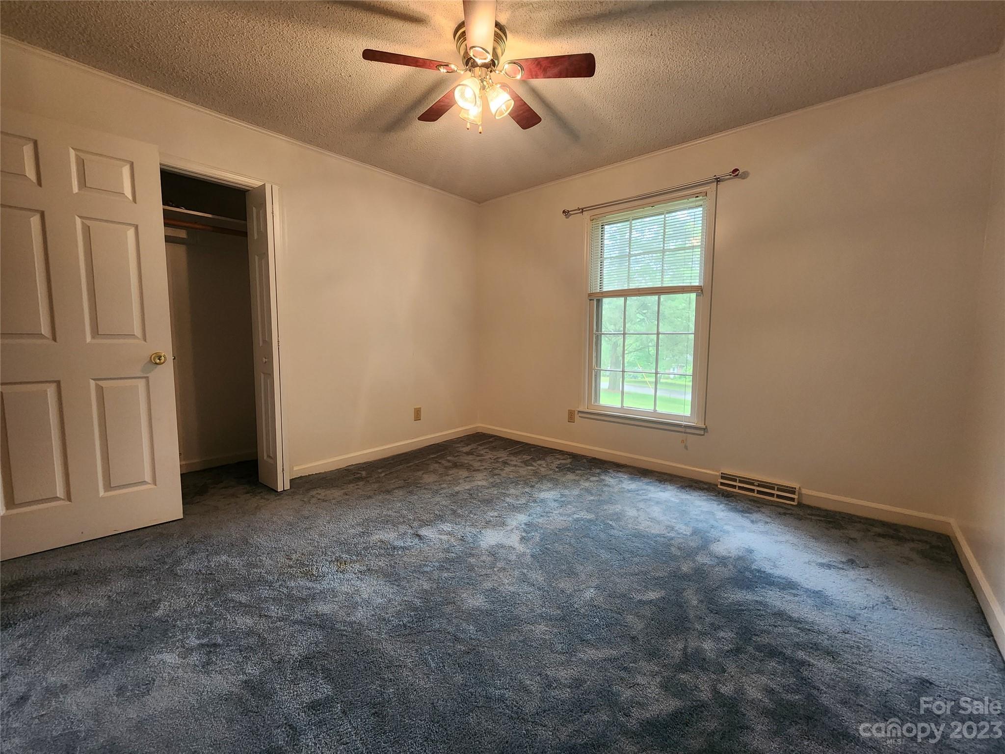 128 Devine Street Stanley, NC 28164 - Photo 27 of 36 an empty room with windows and fan