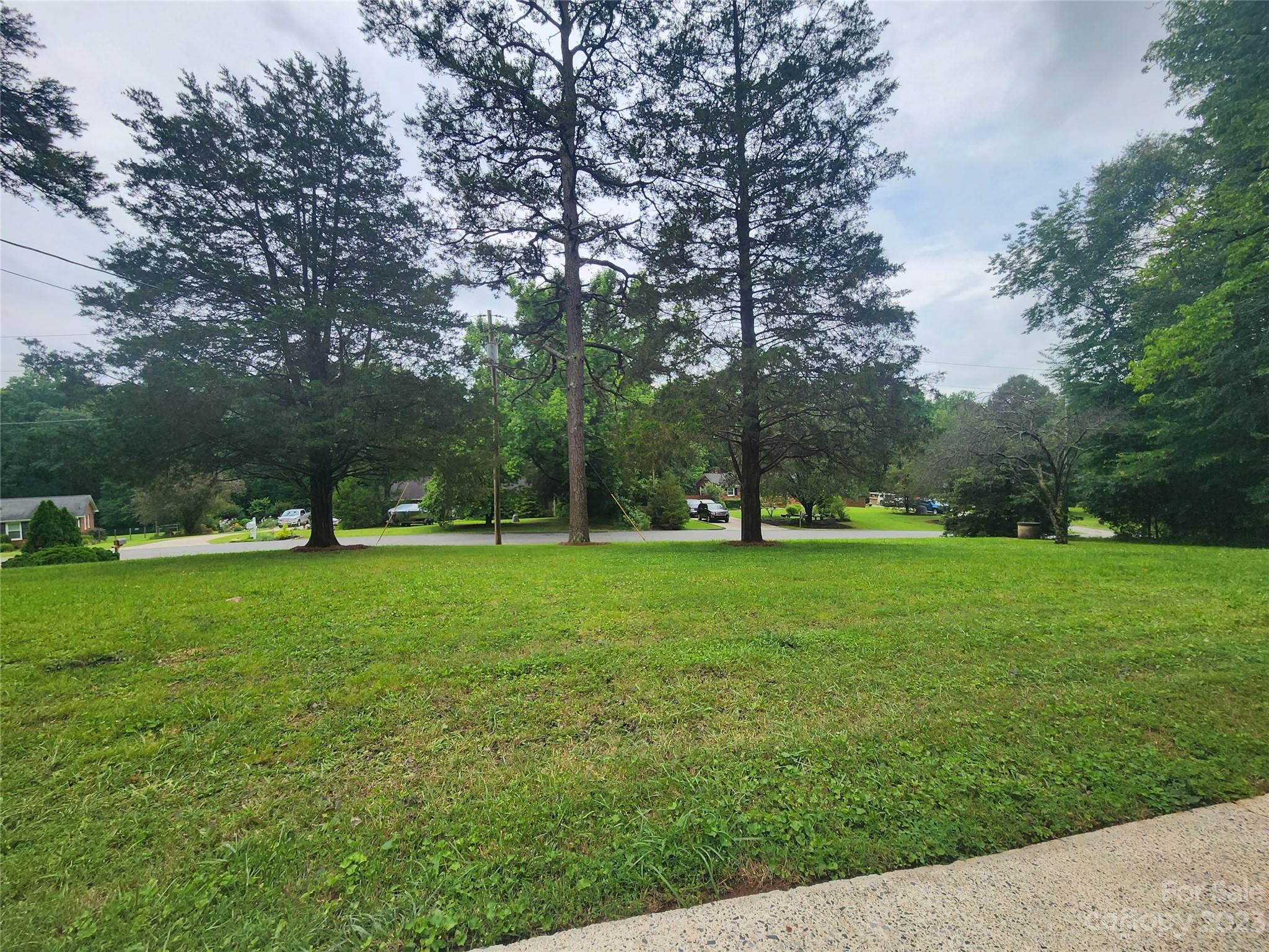 128 Devine Street Stanley, NC 28164 - Photo 4 of 36 a view of a park with trees and wooden fence