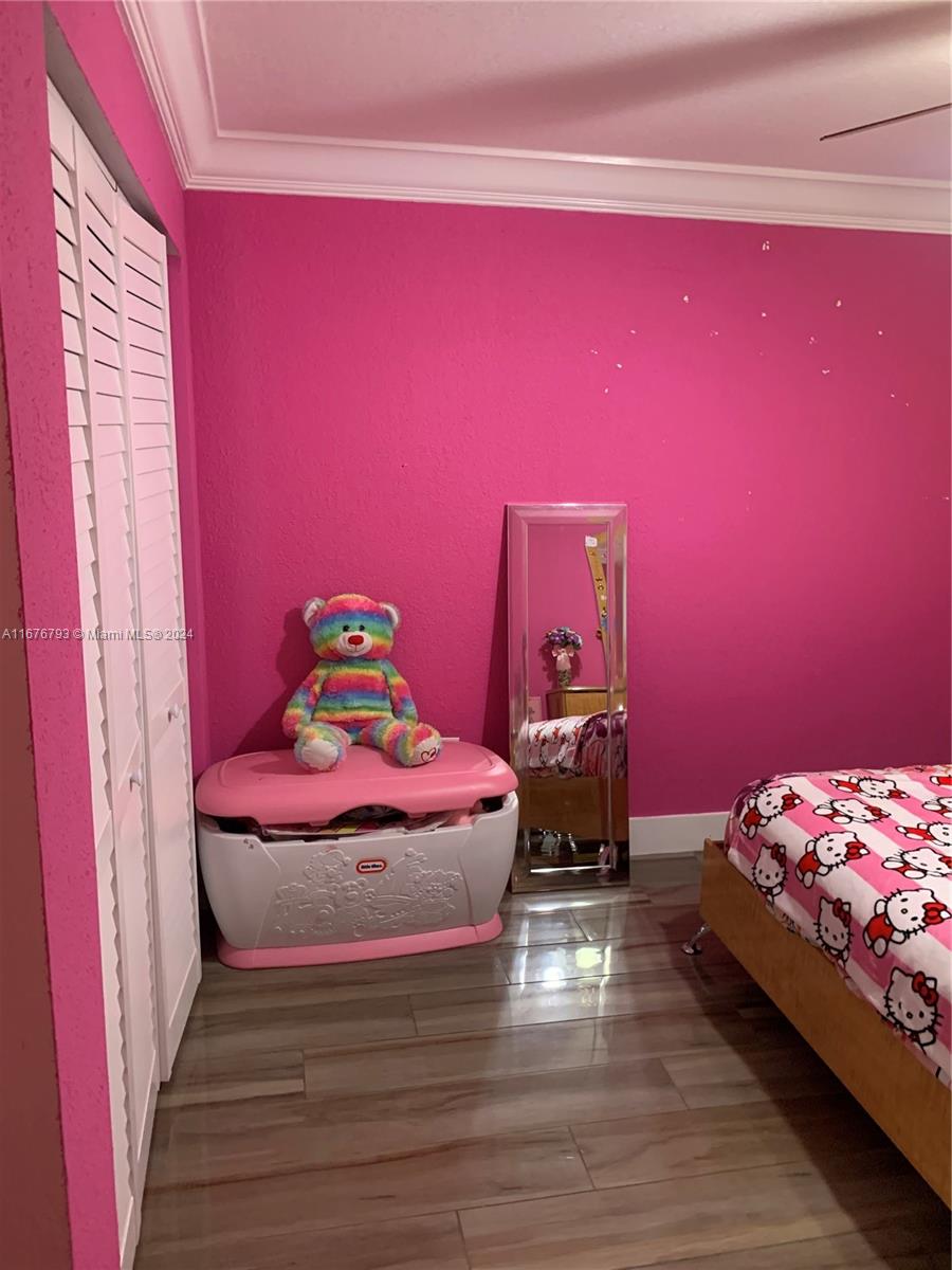 21048 Southwest 118th Place Miami, FL 33177 - Photo 21 of 26 a bedroom with a bed and a window