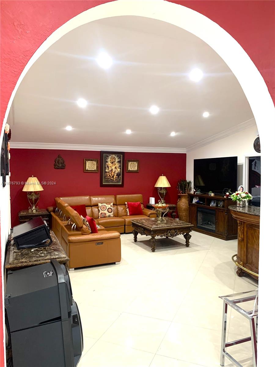 21048 Southwest 118th Place Miami, FL 33177 - Photo 6 of 26 a living room with furniture and a flat screen tv