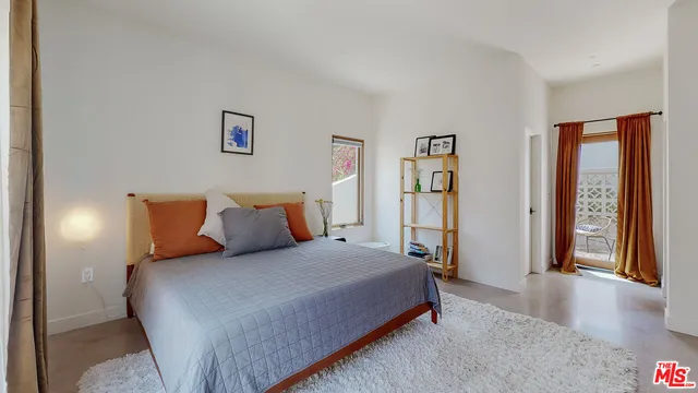 a bedroom with a large bed and a walk in closet