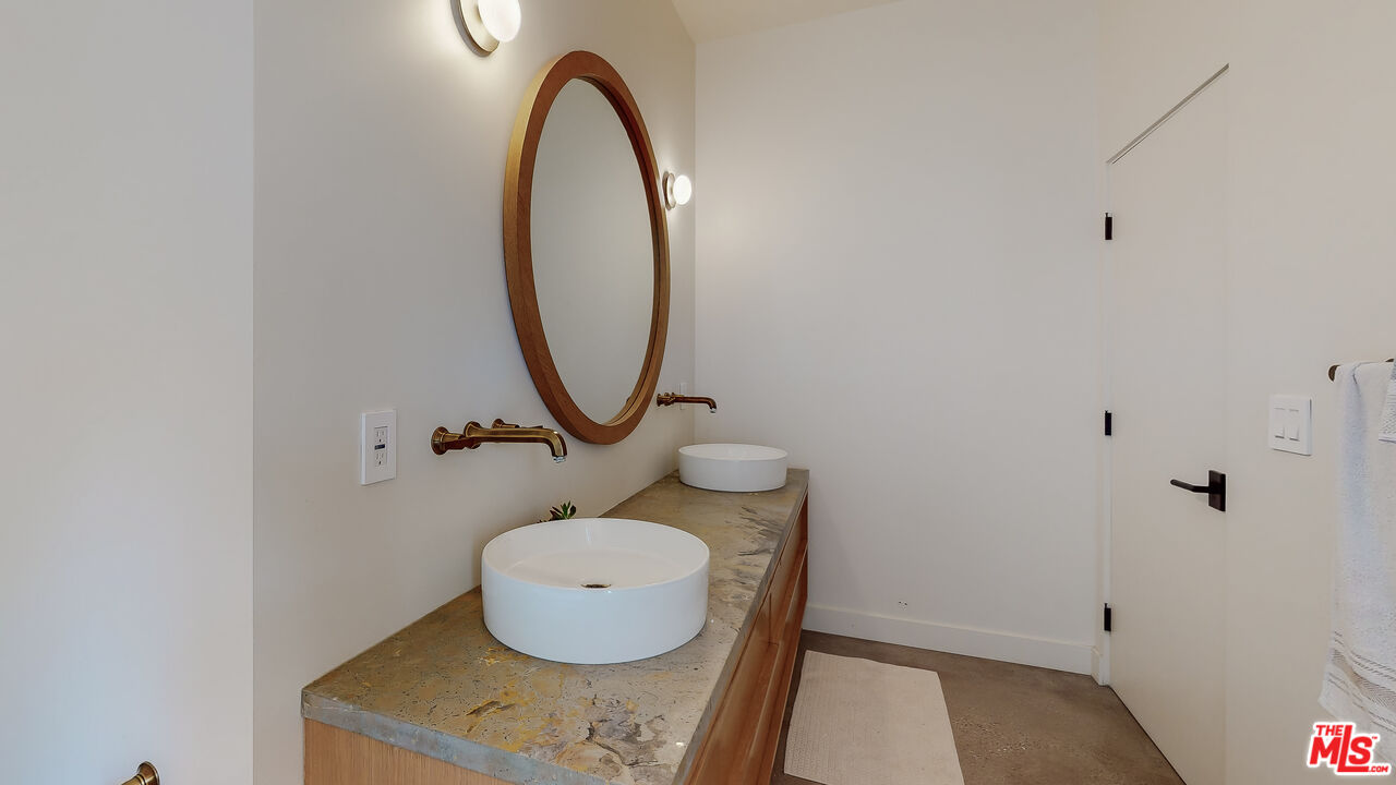4865 Wicopee Street Los Angeles, CA 90041 - Photo 16 of 43 a bathroom with a sink mirror and toilet