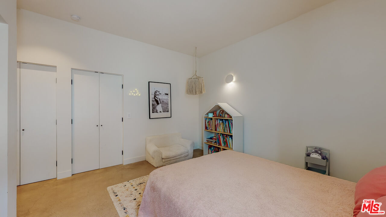 4865 Wicopee Street Los Angeles, CA 90041 - Photo 26 of 43 a bedroom with a bed and a book shelf