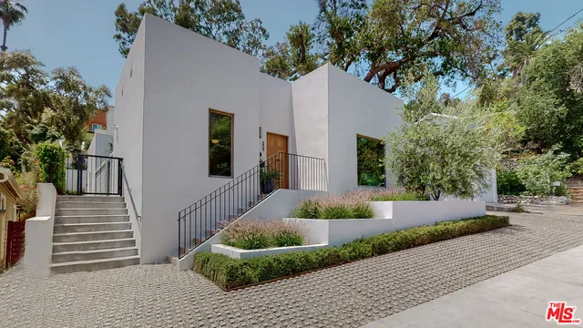 a front view of a house with garden