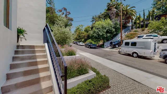 a view of a street with cars on road