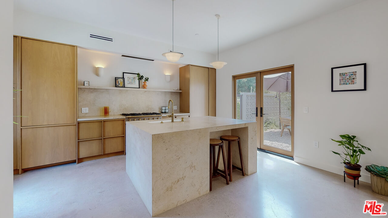 4865 Wicopee Street Los Angeles, CA 90041 - Photo 6 of 43 a kitchen with stainless steel appliances granite countertop a refrigerator a sink a stove and a wooden floors