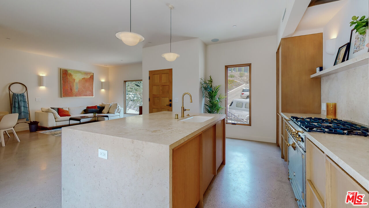4865 Wicopee Street Los Angeles, CA 90041 - Photo 8 of 43 a kitchen with sink a stove and chairs