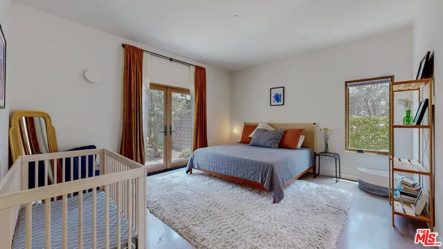 a bedroom with furniture and a window