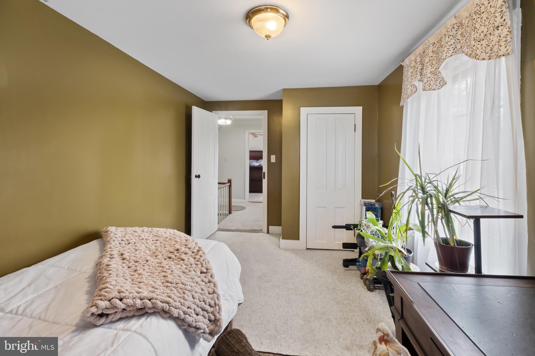 3421 Allen Road Eden, MD 21822 - Photo 43 of 56 a bedroom with a bed table and a potted plant