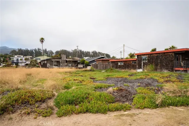 a view of a house with a yard and sitting area