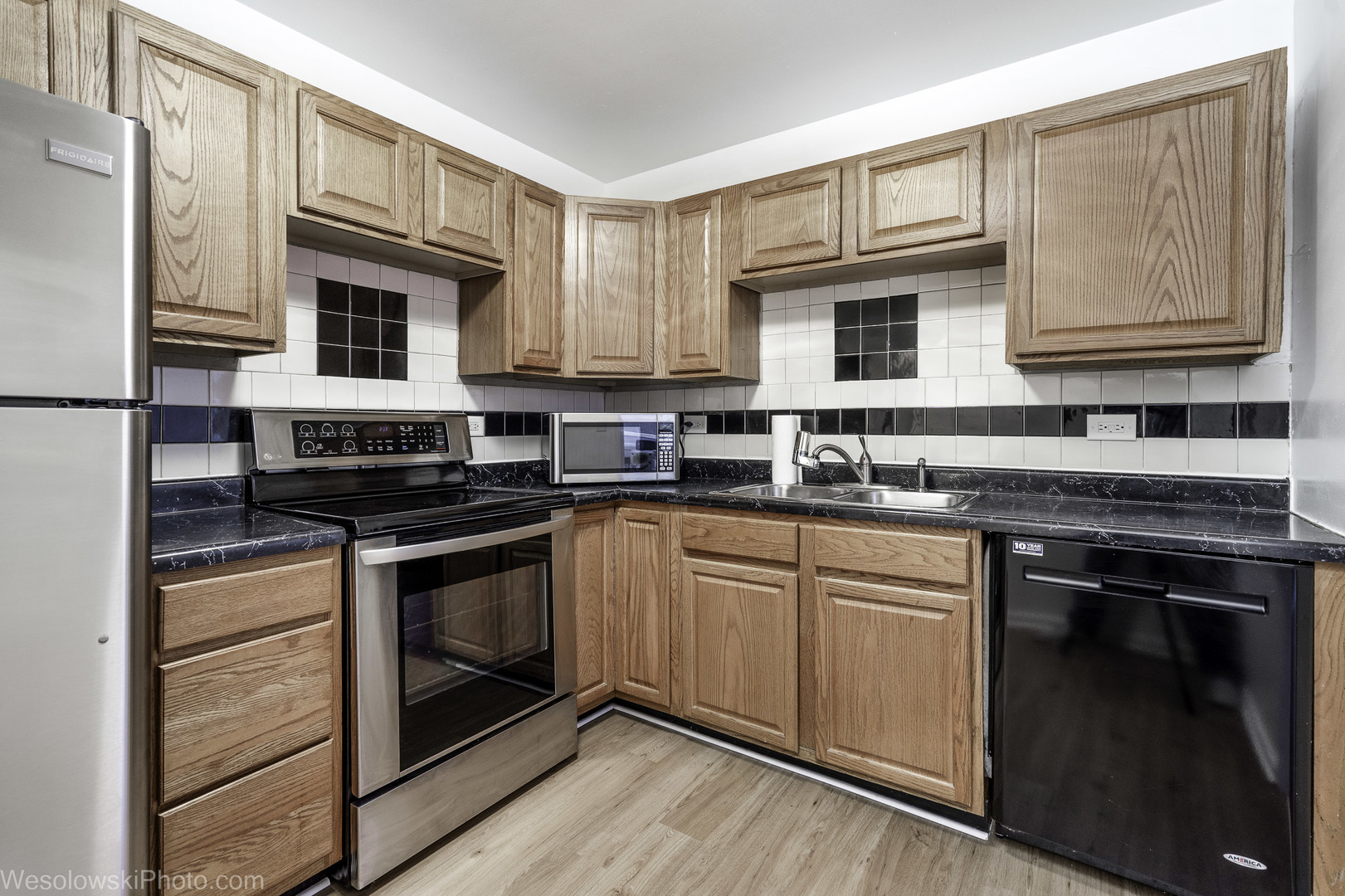6301 North Sheridan Road, Unit 6C Chicago, IL 60660 - Photo 2 of 20 a kitchen with stainless steel appliances granite countertop a stove a sink and a microwave